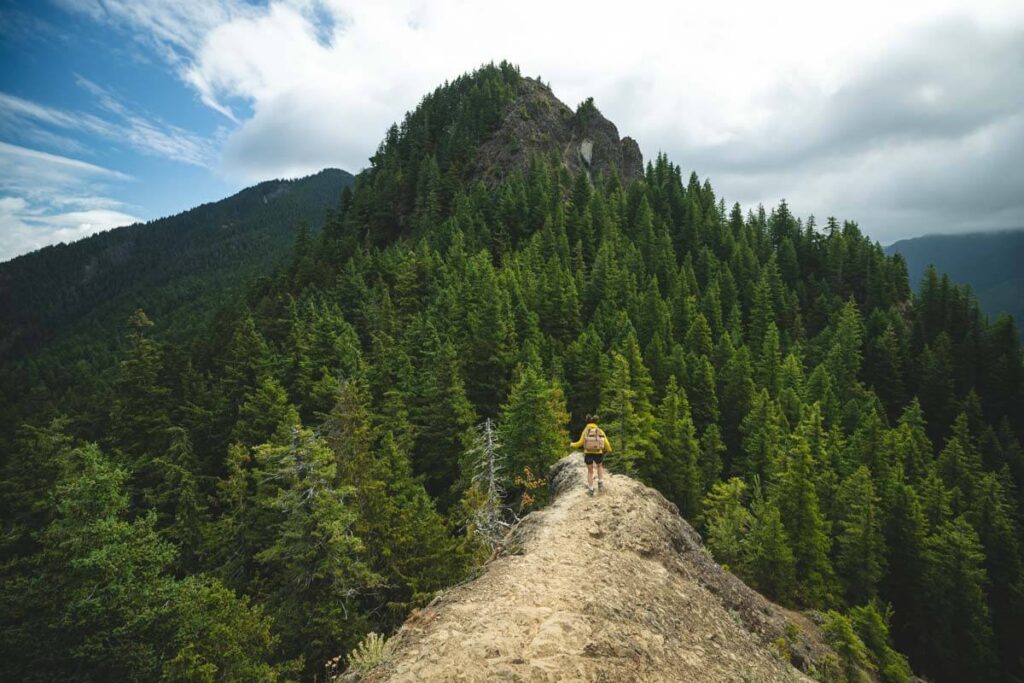 Woman hiking ridge on the Mount Storm King Trail