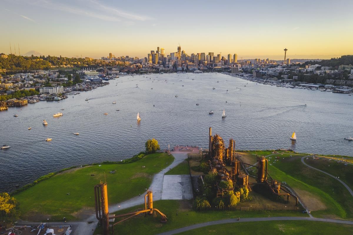 Aerial view of Gas Works Park at sunset and a view over Seattle Bay all the way to downtown.
