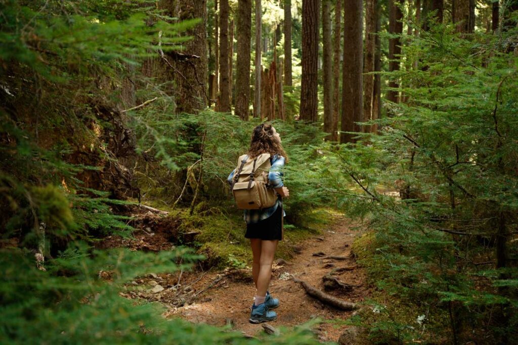 Woman hiking through trees