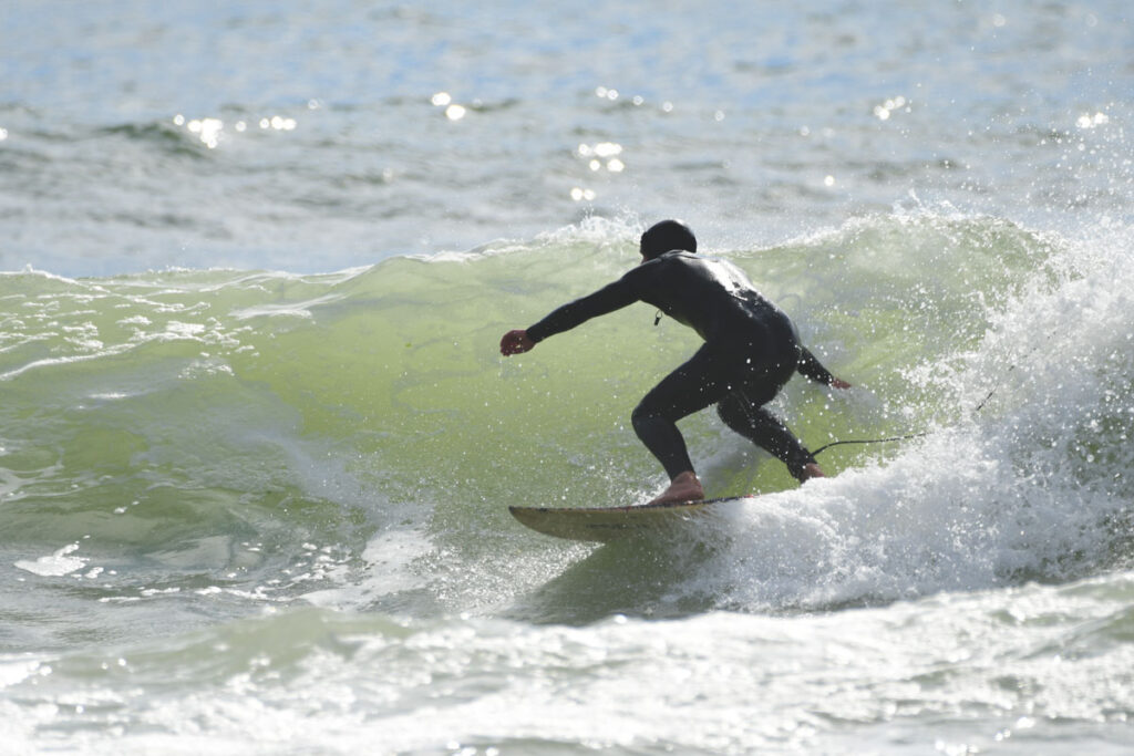 Surfer on wave at Long Beach, Washington