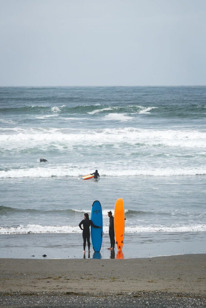 Surfers on the beach at Westhaven State Park, Westport, Washington