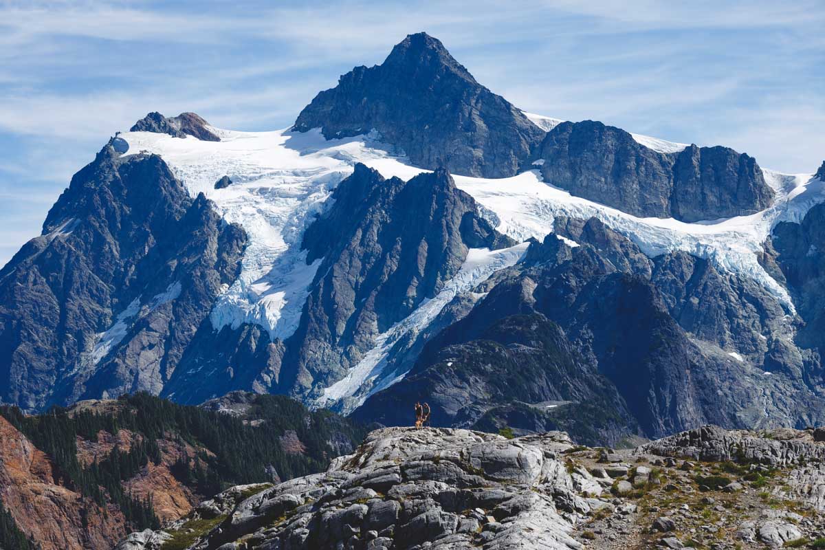 View from Artists Point of a hikier in front of a huge mountain in the North Cascades.