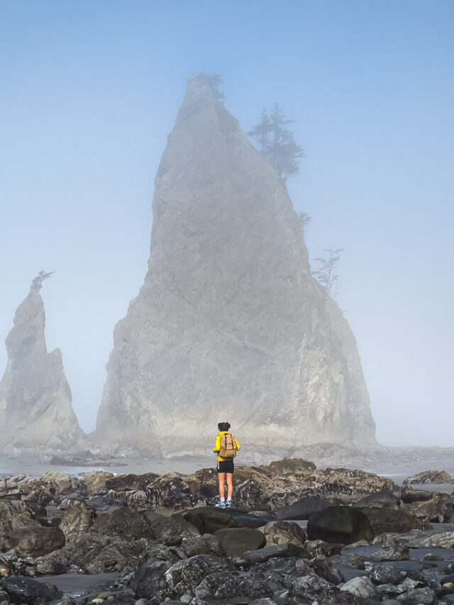 Hiker at Rialto Beach one of the best things to do in Olympic National Park