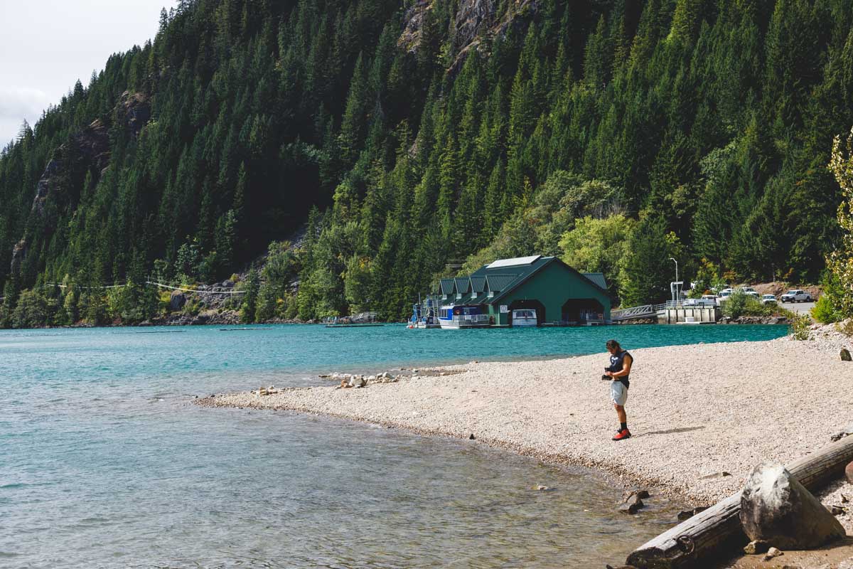 Hiker on beach at Diablo Lake on the best hikes in the North Cascades