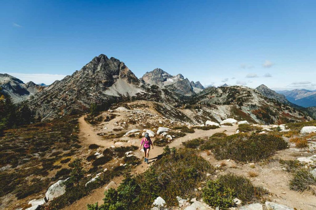 Hiker with view of Mount Benzarino on the Maple Pass Loop