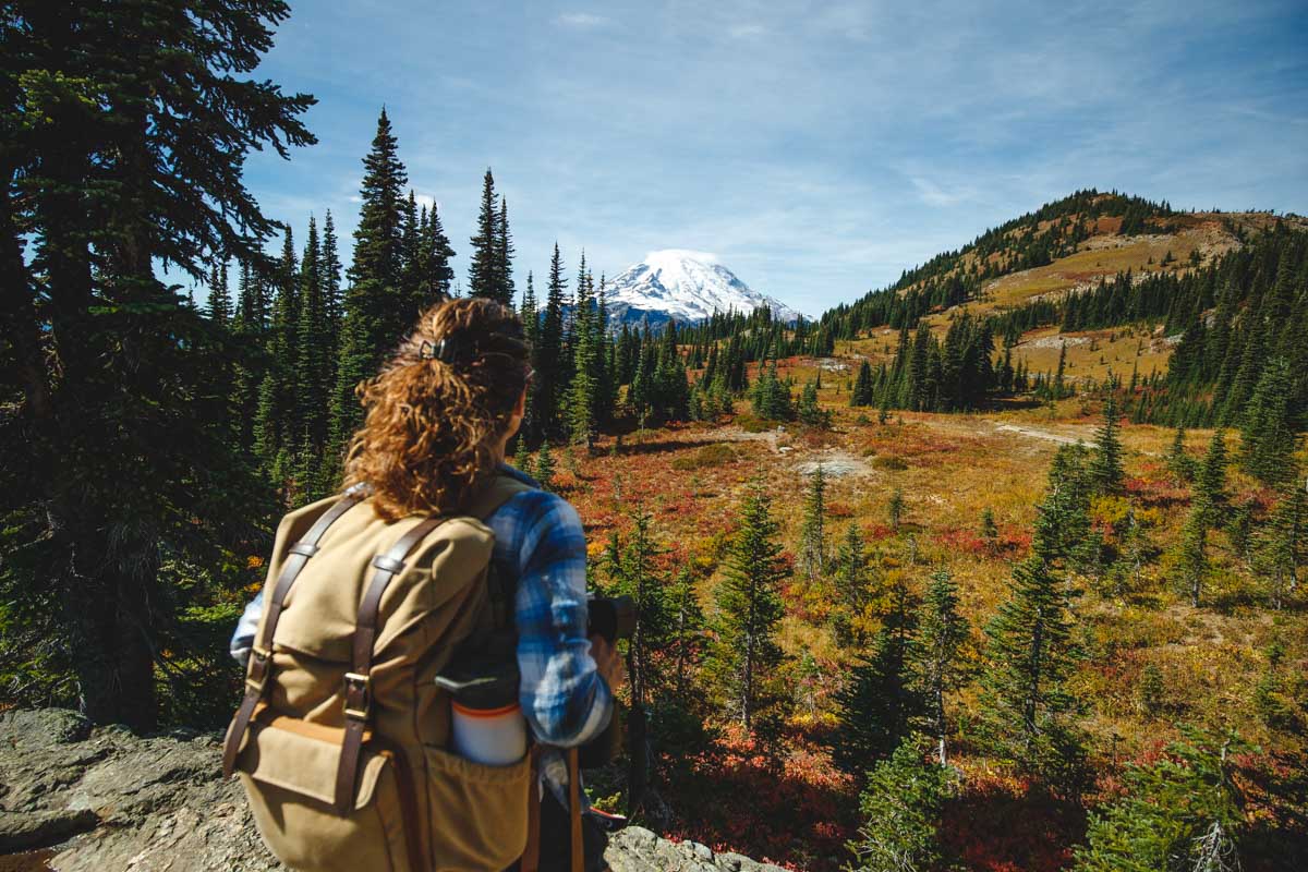 Hiker with view of Mount Rainier on the Naches Peak Loop Trail