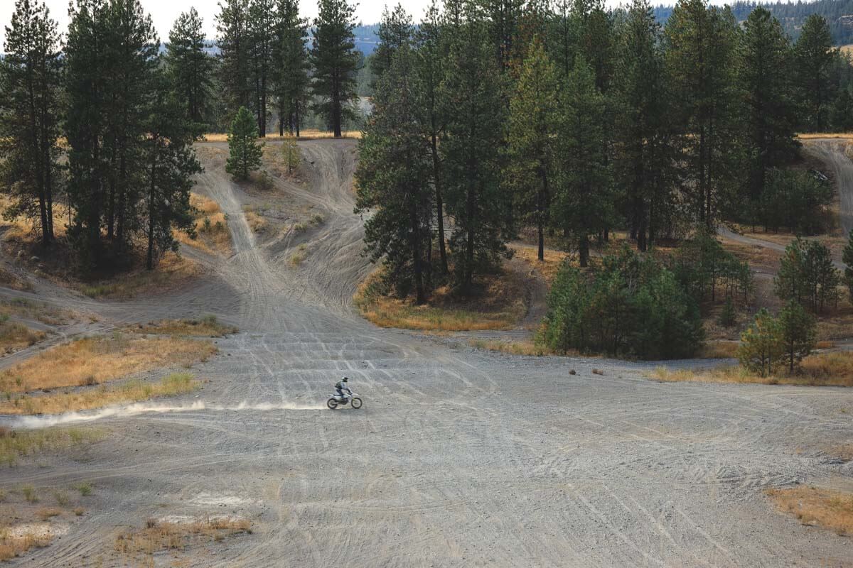 A motocross rider speeding across the OHV area in Riverside State Park.