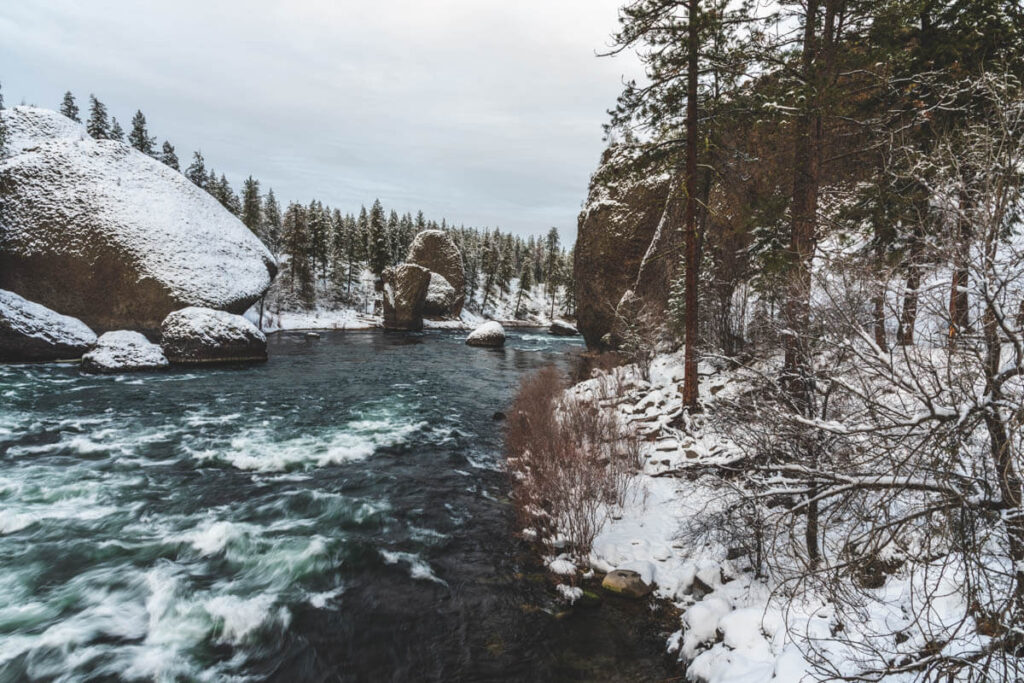 A snow covered Spokane River during winter in Riverside State Park.