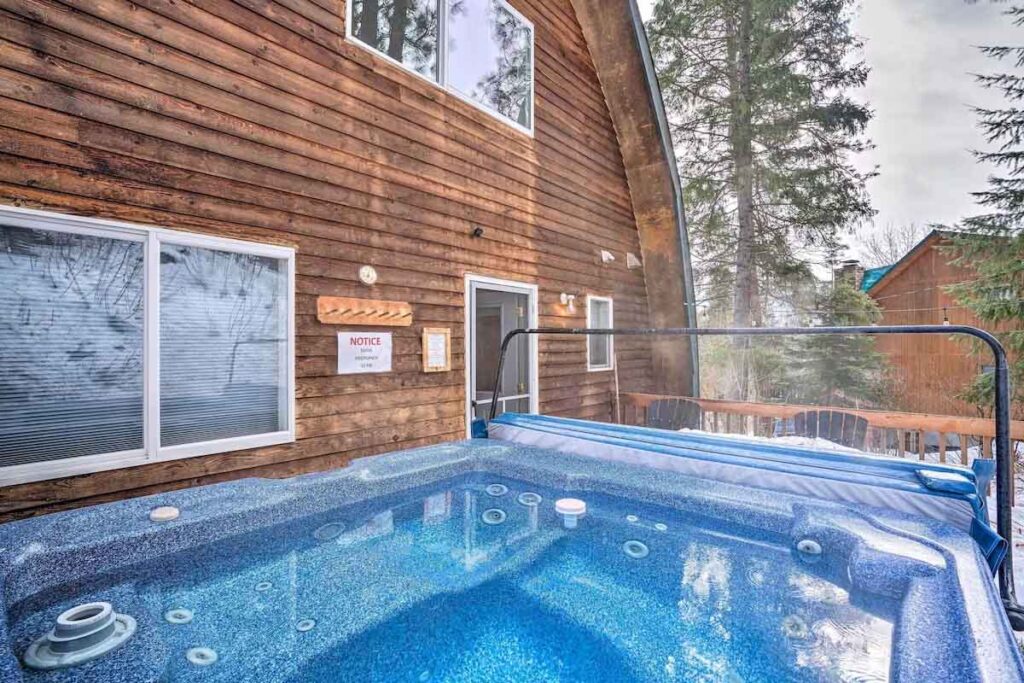 A steamy hot tub in winter outside a cabin in Washington.