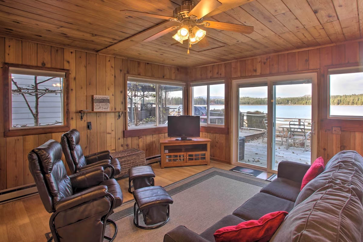 A cozy living area with a sofa an two arm chairs inside a cabin next to Diamond Lake.