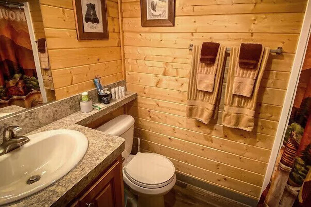 A cozy wooden cabin bathroom.
