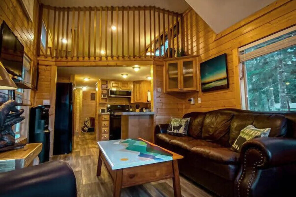 A full view of the wooden interior of a river front cabin in Washington.