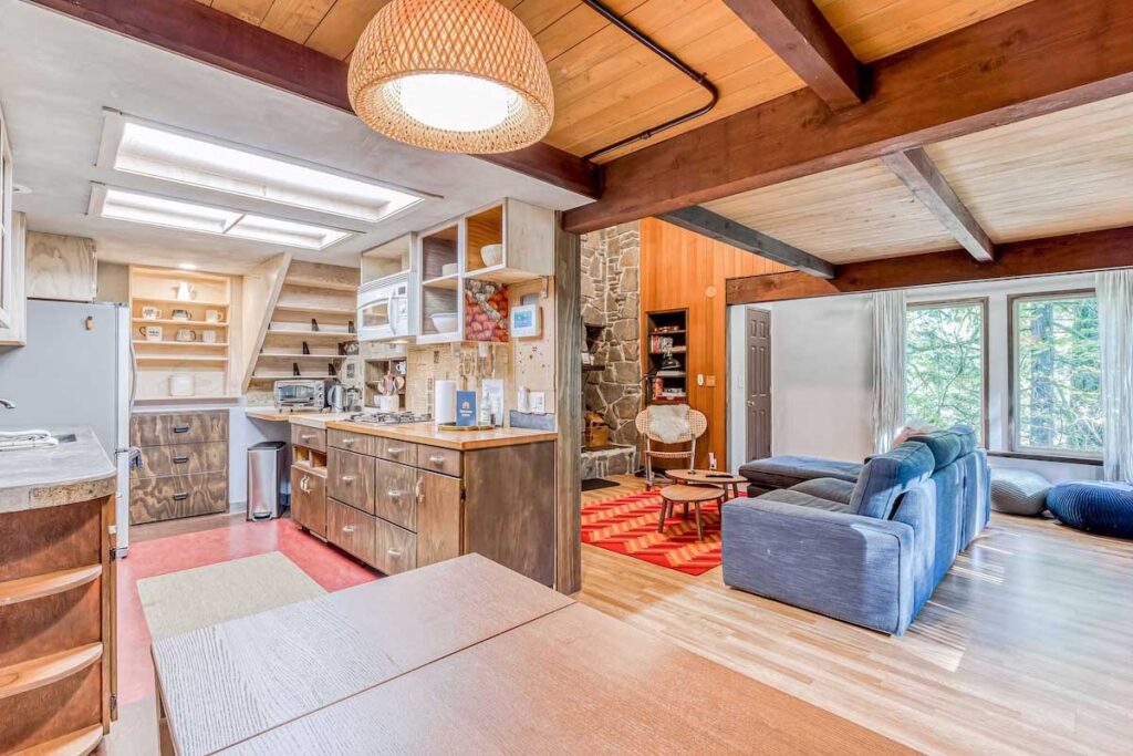 A full view of the living, dining and kitchen areas inside Rivers Perch Waterfront Cabin.