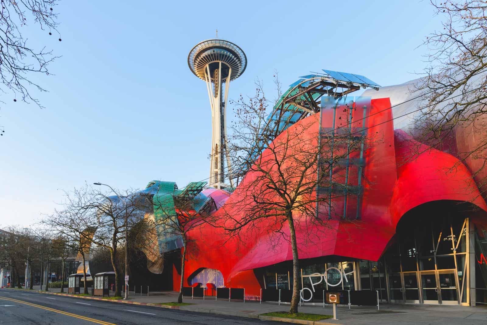 A roadside view of the colorful Mopop Art Museum and Space Needle in Seattle.