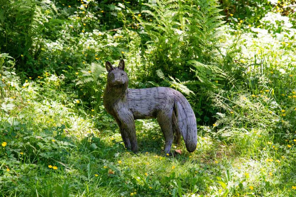 Metal fox statue surrounded by grass at the Port Angeles Fine Art Center.