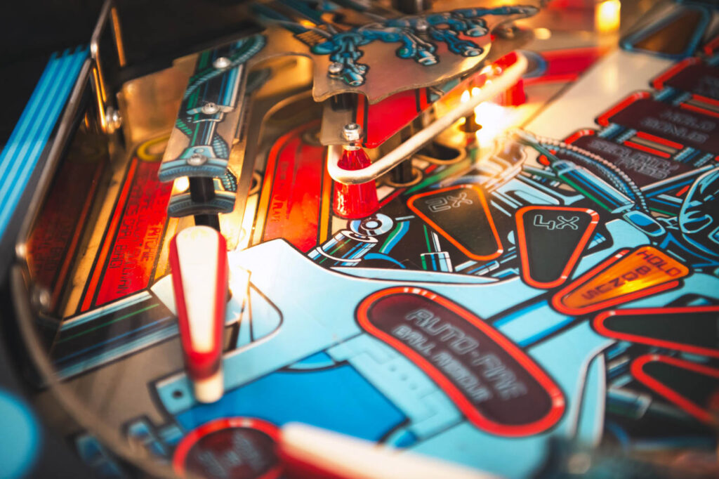 A close up shot of a red and blue pinball machine.