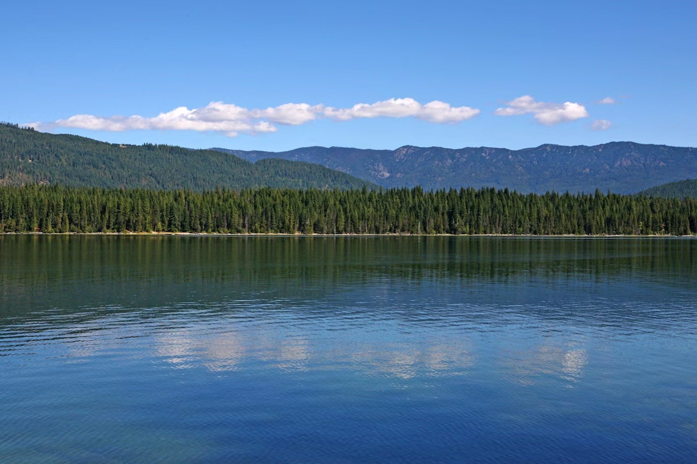 View across the blue waters of Lake Wenatchee and the forests and mountains beyond.