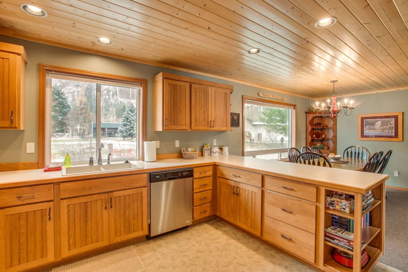 The kitchen and dining area of the Serene Mountain View Cabin with a wooden finish.