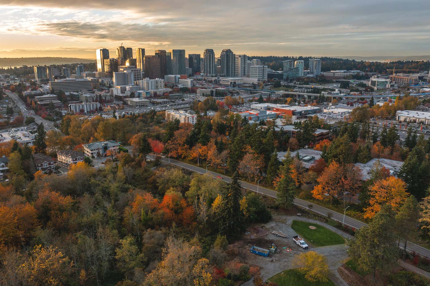 Sunset over downtown Bellevue with beautiful fall-colored trees in the foreground.