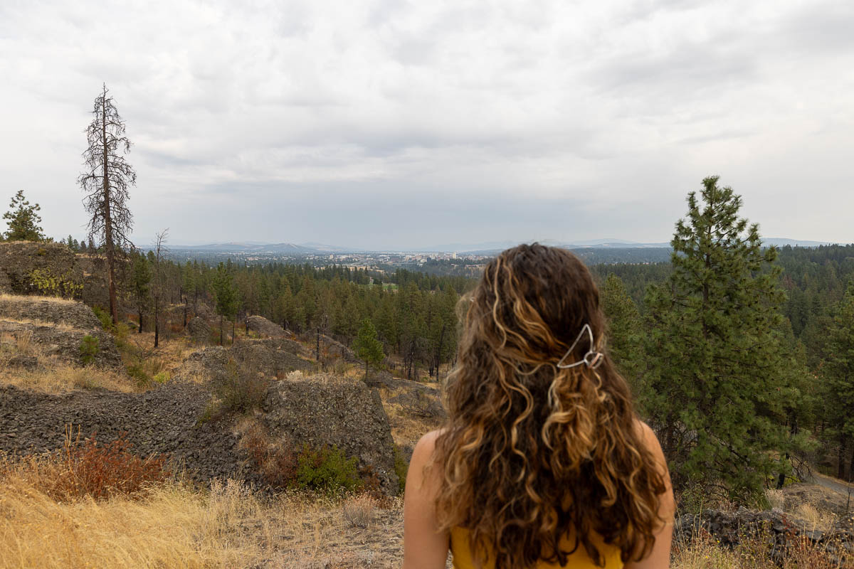 woman over looking Rimrock View Trail & Palisade Park.